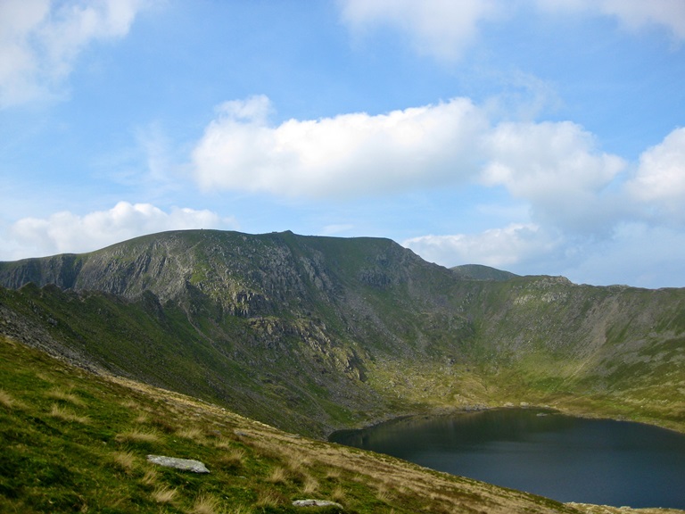 A dip in the hills leading to a body of water