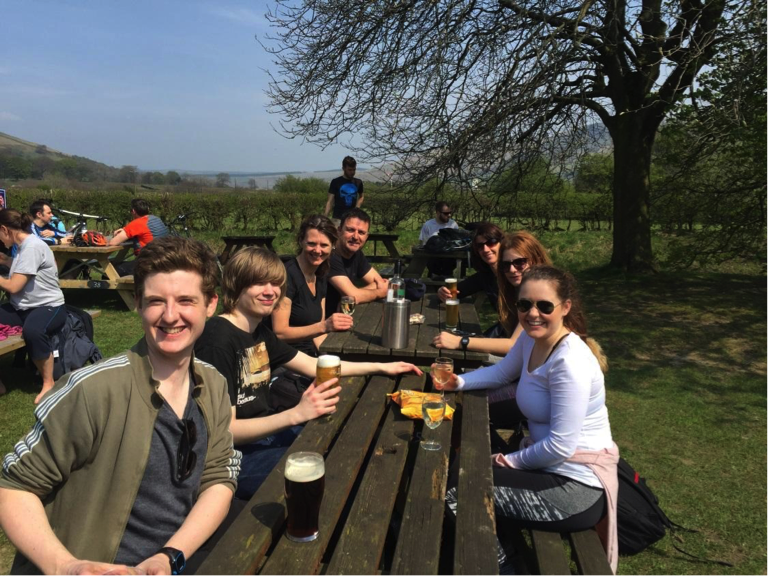 The team outside on a pub bench