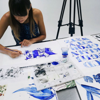 Gemma painting letters in blue