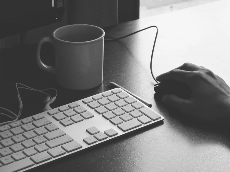 Keyboard and mouse accompanied by coffee mug