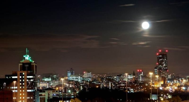 Manchester buldings lighting up in the dark sky